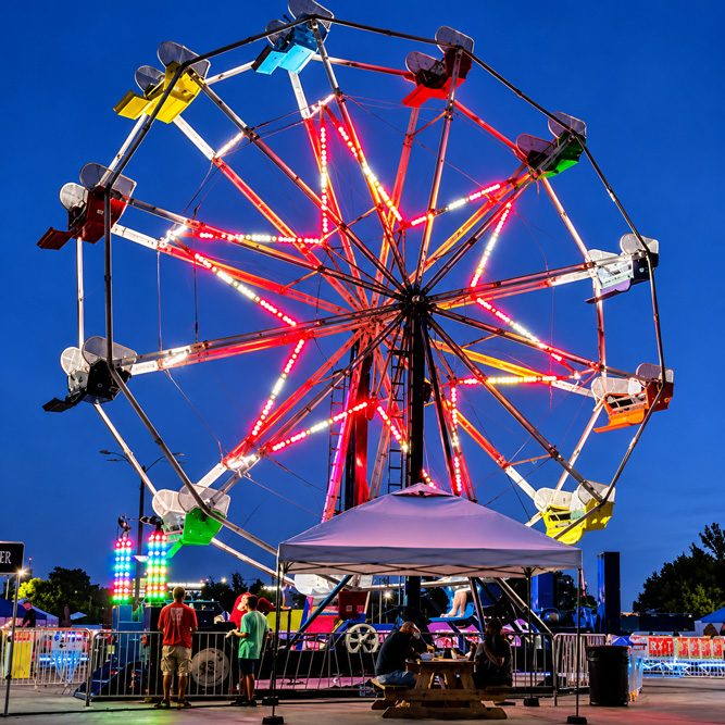 Ferris wheel lit against the evening sky at a St. Louis festival