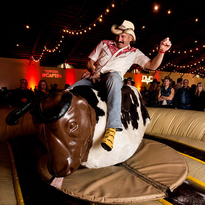 Mechanical bull with soft perimeter padding at an evening event