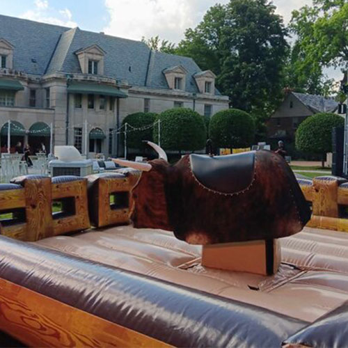Mechanical bull with padded surround at an outdoor St. Louis event